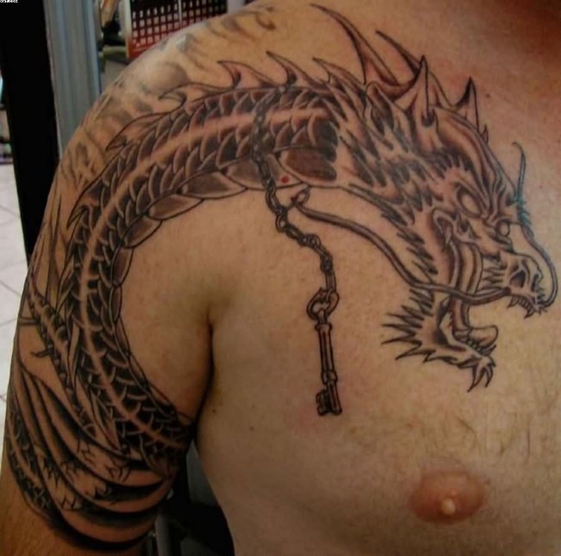 Dragon With Key Chain Tattoo On Chest To Shoulder
