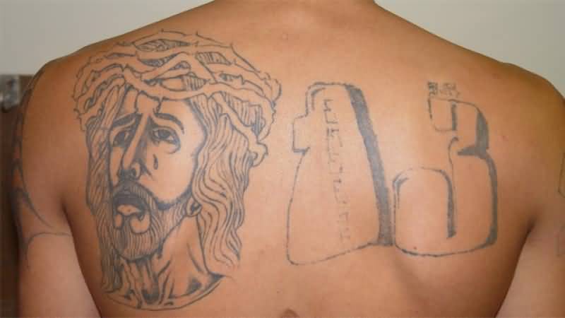 Face With Thirteen Number Tattoo On Upper Back