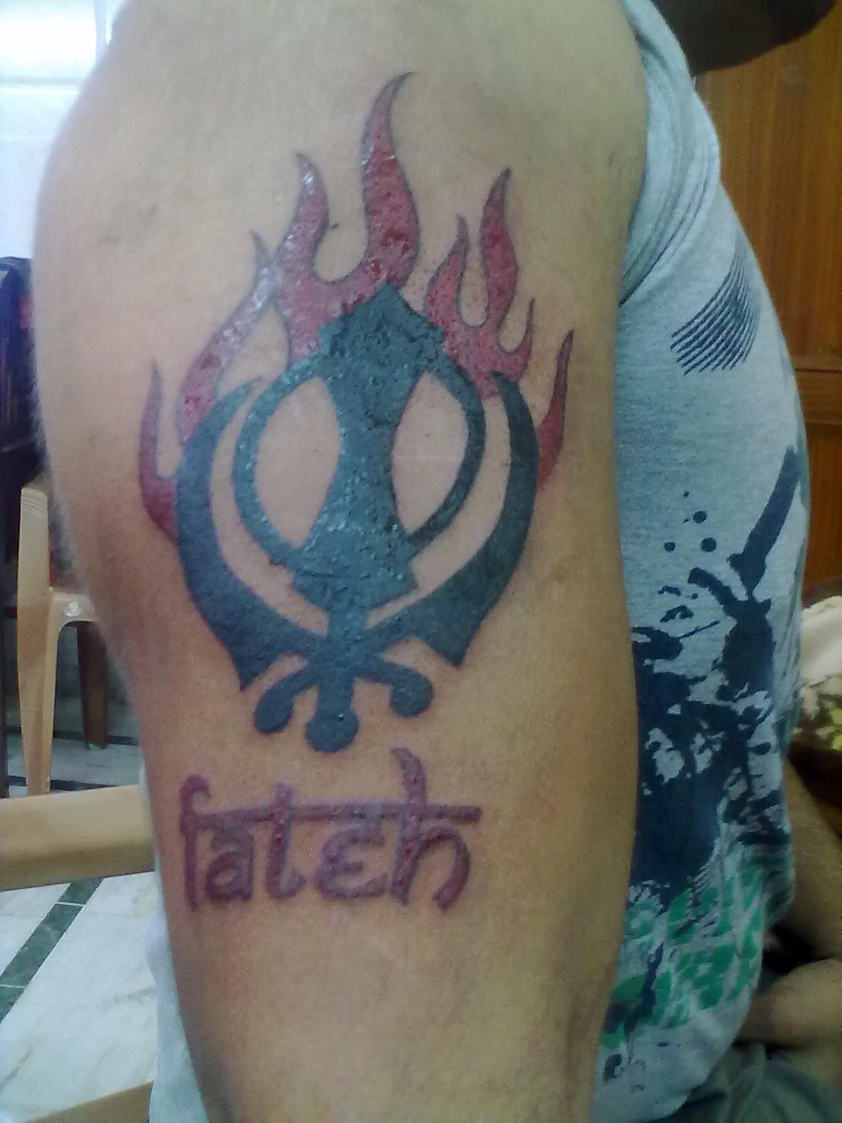 Flaming Khanda With Fateh Word Punjabi Tattoo On Half Sleeve