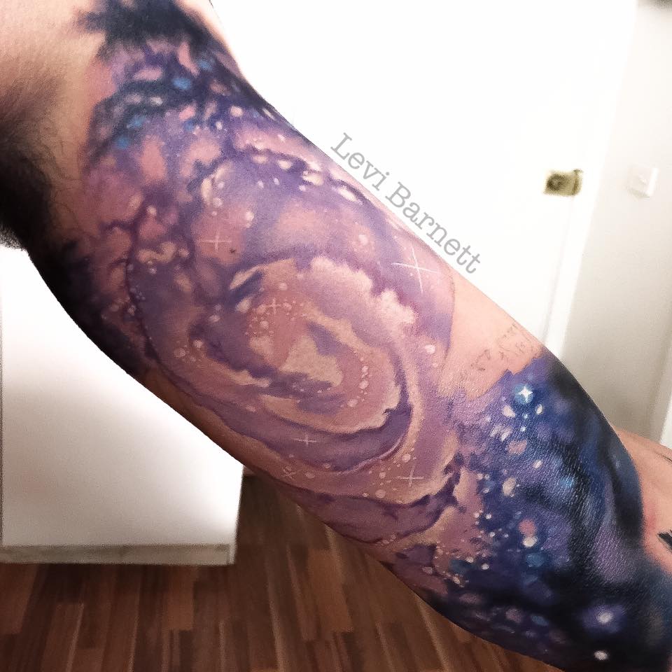 Galaxy tattoo on arm by Levi Barnett
