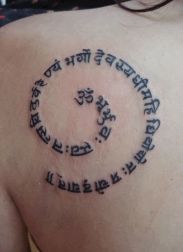 Gaytri Mantra In Spiral Tattoo On Left Back Shoulder