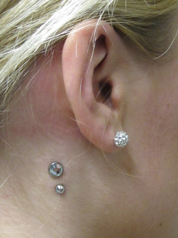 Girl Right Ear Lobe And Surface Side Neck Piercing