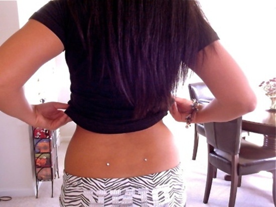 Girl Showing Her Lower Back Piercing