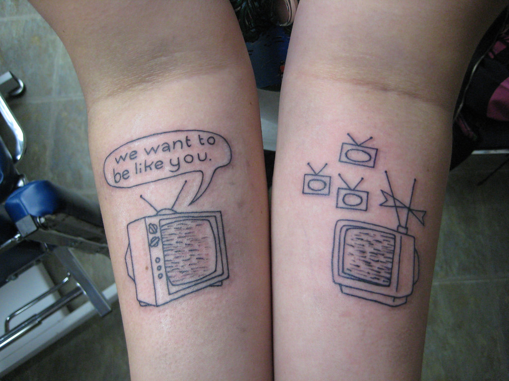 Grey Television Tattoos On Both Forearms