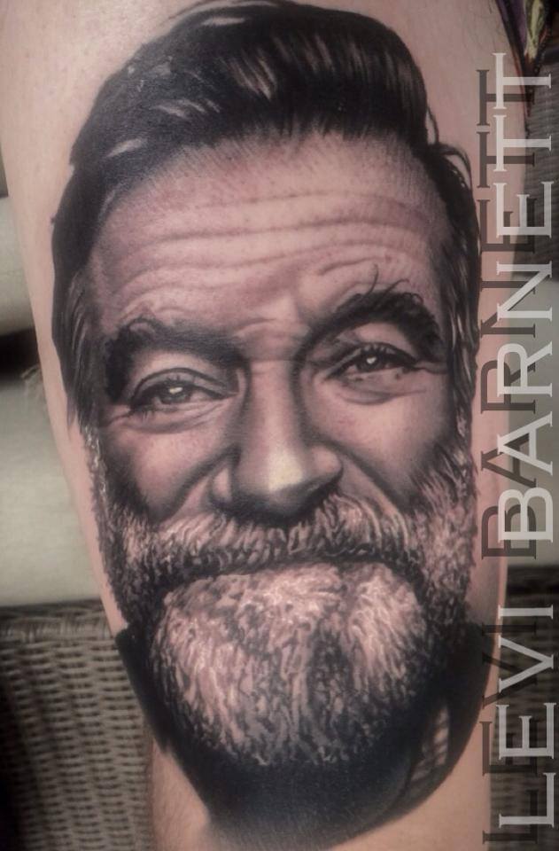 Grey ink portrait tattoo on arm by Levi Barnett