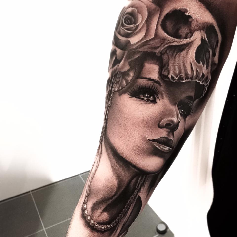 Grey ink skull girl and rose tattoo on arm by Levi Barnett