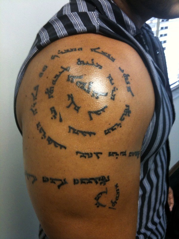 Language Spiral Tattoo On Right Shoulder