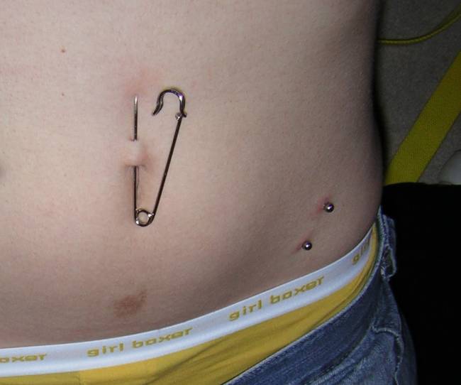 Left Surface Hip And Surface Navel Piercing With Safety Pin