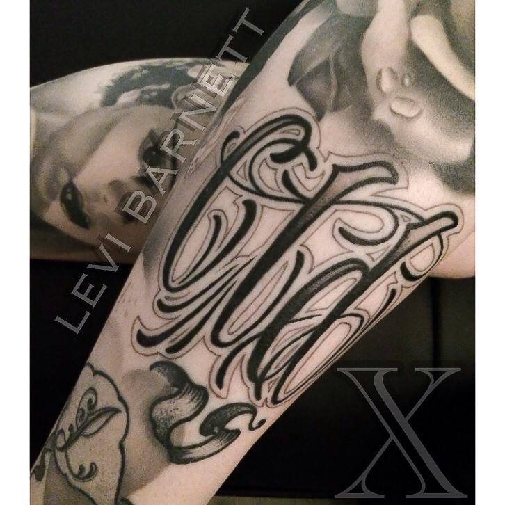Lettering tattoo on arm by Levi Barnett