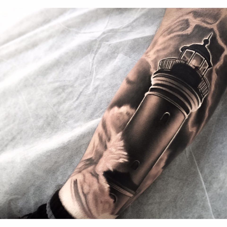 Lighthouse tattoo on arm by Levi Barnett
