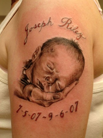 Little Baby Portrait Remembrance Tattoo On Left Shoulder