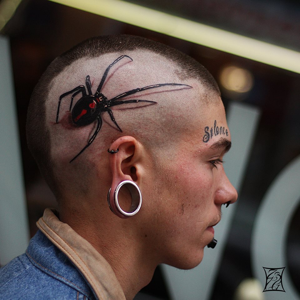 Lobe Stretching And Black Widow Tattoo On Head by Gabor Zsil