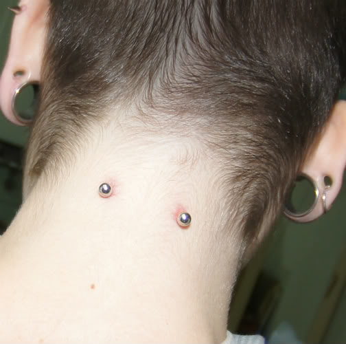 Lobe Stretching And Surface Back Neck Piercing