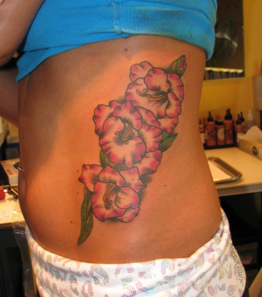 Lovely Gladiolus Flower Tattoo On Side Rib For Girls