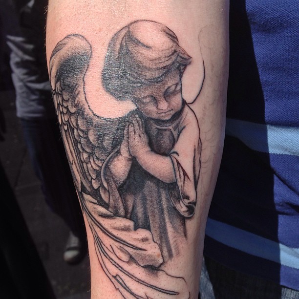 Lovely Grey Ink Praying Angel Cherub Tattoo On Arm