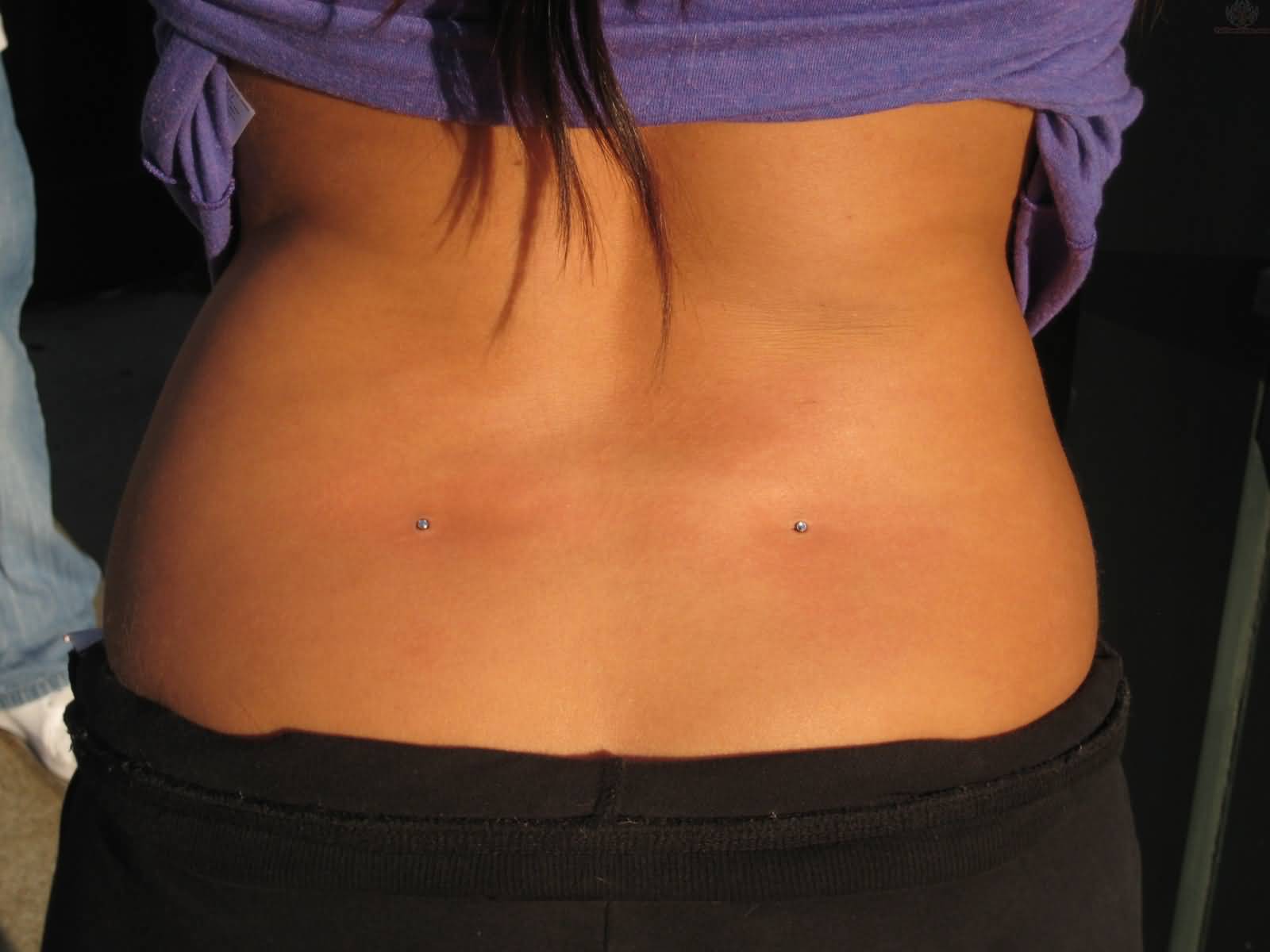 Lower Back Piercing With Tiny Dermals