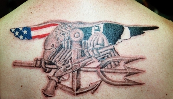 Navy Seal With American And Pow Flags Tattoo On Upper Back