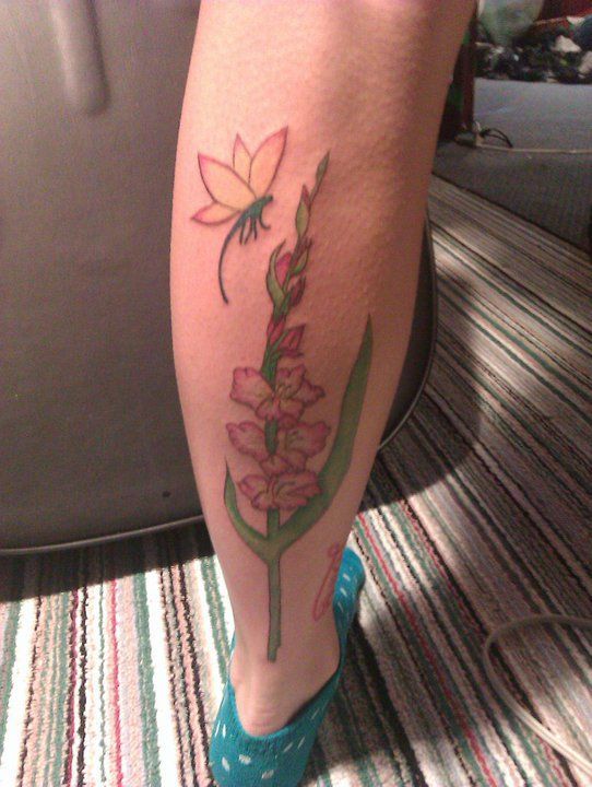 Nice Gladiolus Flower Tattoo On Leg
