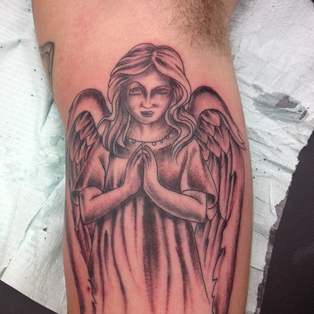 Nice Grey Ink Praying Angel Tattoo On Biceps