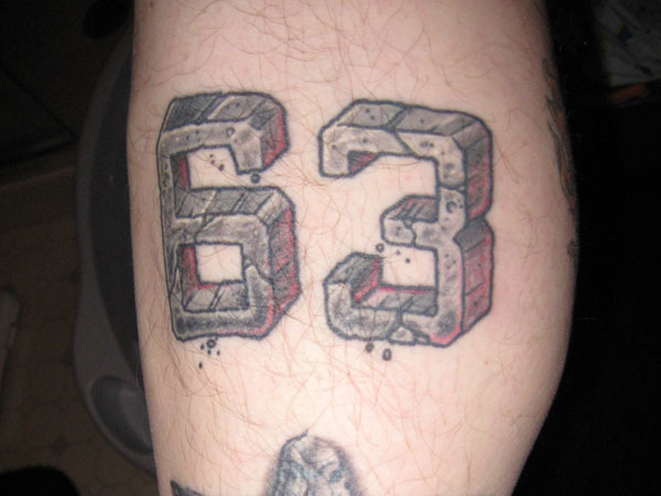 Number 63 Rock Style Tattoo On Arm