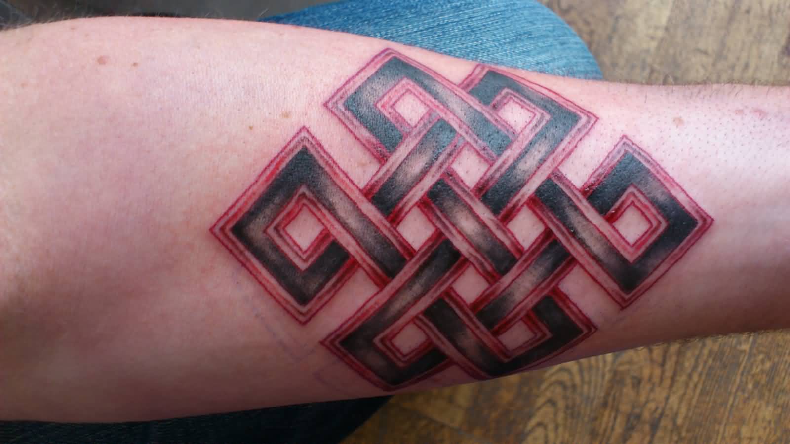 Red And Black Endless Knot Tattoo On Arm