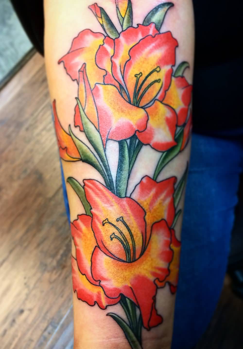 Red And Yellow Gladiolus Flower Tattoo On Forearm