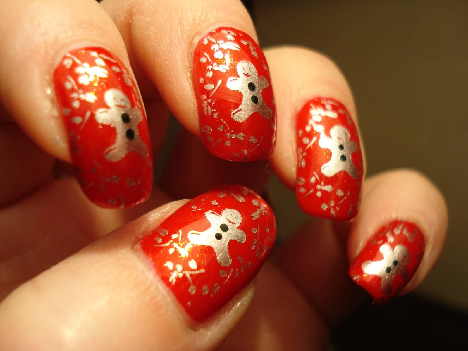 Red Base Nails With Silver Gingerbread Man Design Nail Art