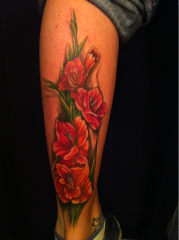Red Color Gladiolus Flowers Tattoo On Leg