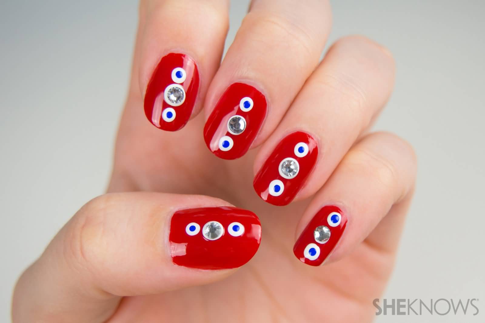 Red Nails With White And Blue Polka Dots Nail Art