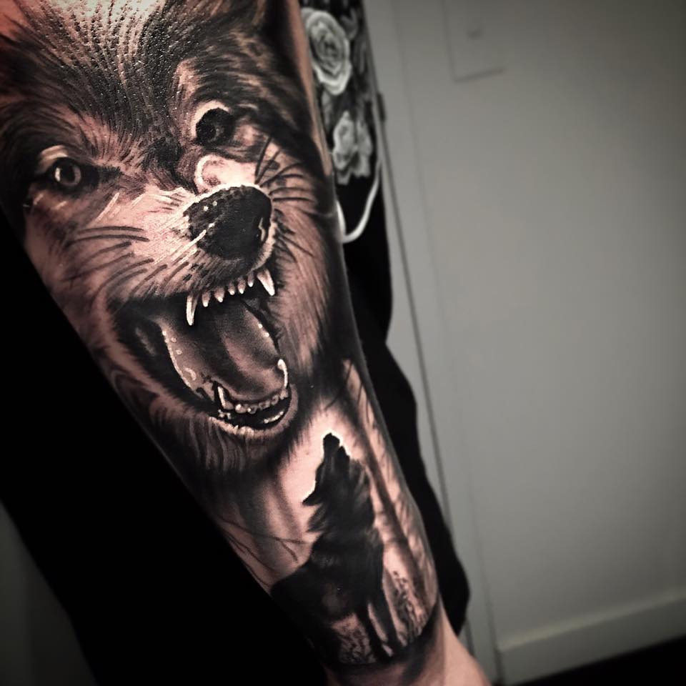 Roaring and howling wolves tattoo by Levi Barnett