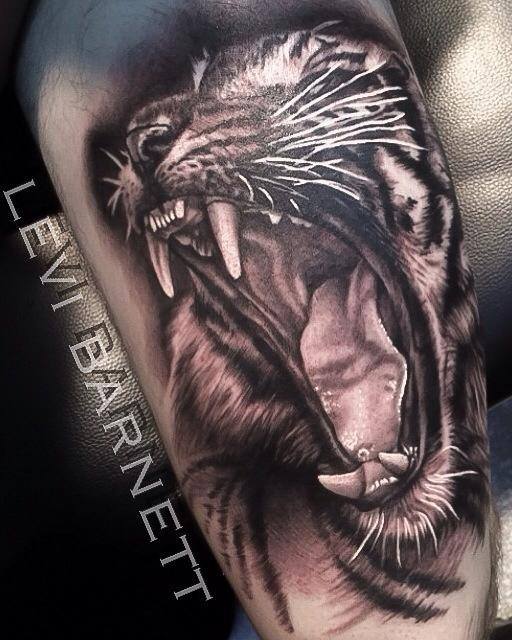 Roaring lion tattoo on arm by Levi Barnett