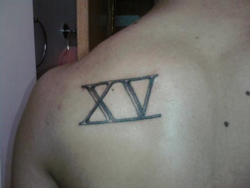 Roman Number Fifteen Tattoo On Left Back Shoulder