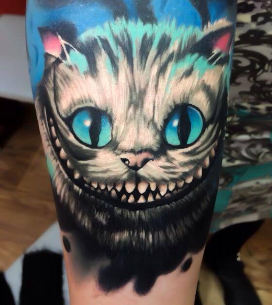 Scary cat tattoo on arm by Levi Barnett