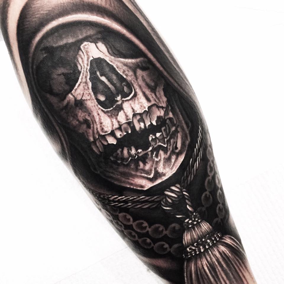 Scary skull tattoo on arm by Levi Barnett