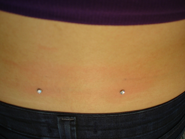 Silver Anchors Lower Back Piercing Image