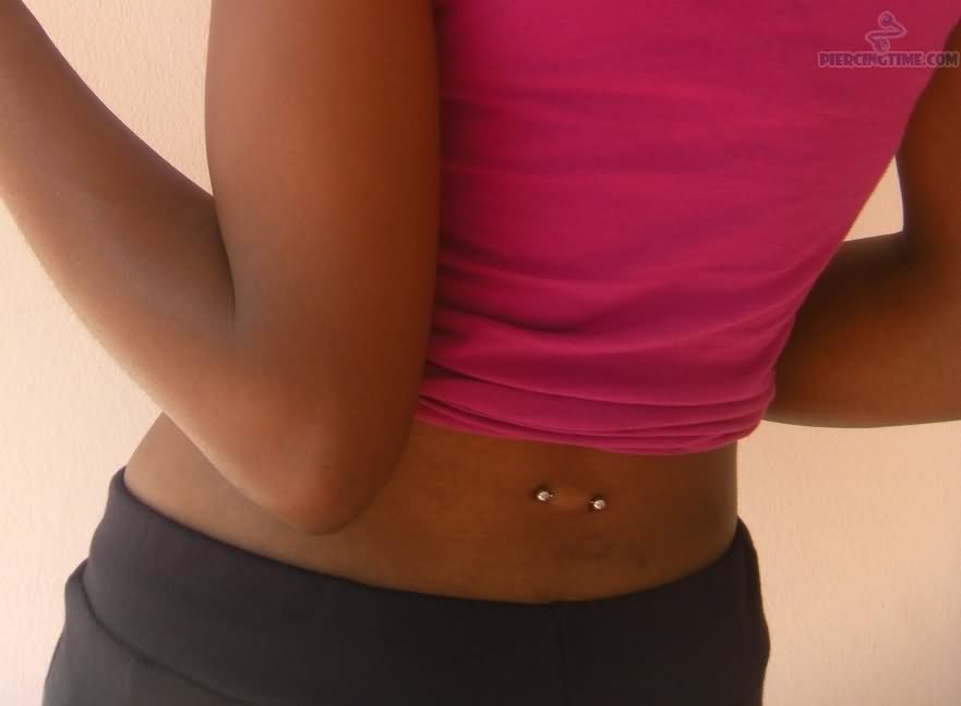 Silver Barbell Lower Back Piercing For Young Girls