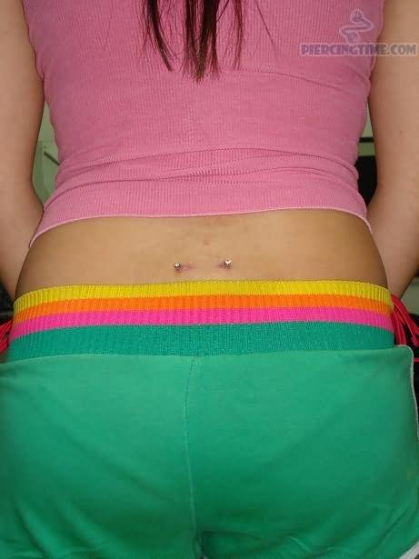 Silver Barbell Lower Back Piercing Picture For Girls