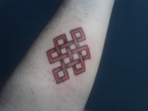 Simple Red Endless Knot Tattoo On Forearm