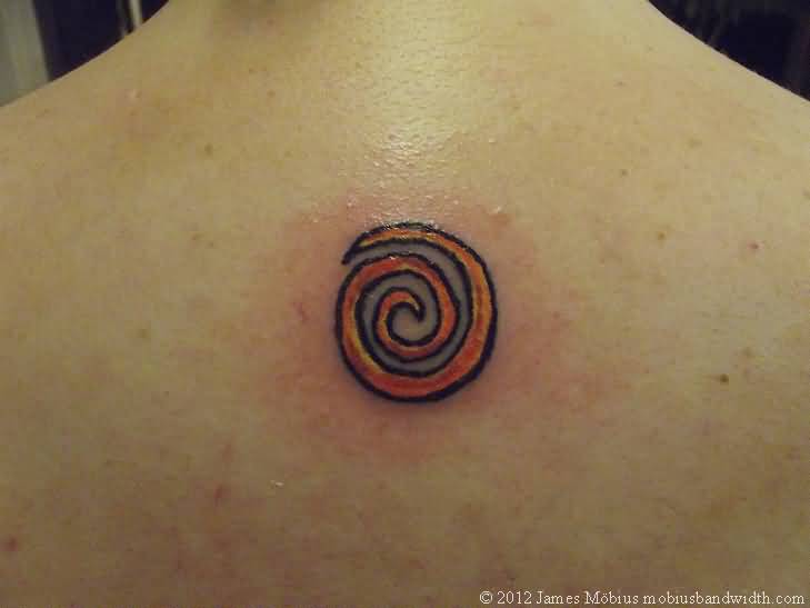 Small Orange Spiral Tattoo On Upper Back By J Mobius