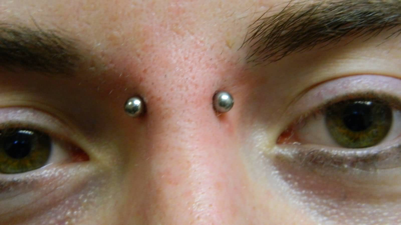 Surface Bridge Piercing With Silver Barbell Closeup Picture