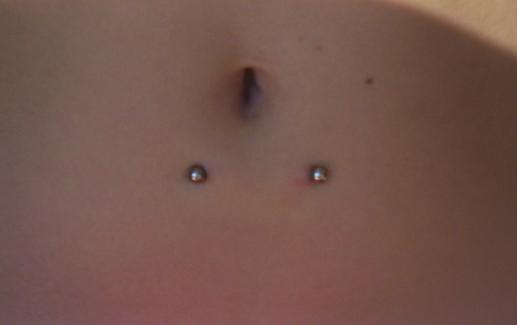 Surface Navel Piercing With Silver Barbell by Drowning