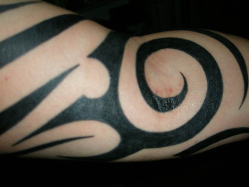 Tribal Spiral Tattoo On Arm