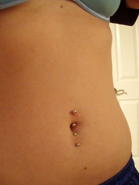 Vertical Surface Navel Piercings With Silver Studs