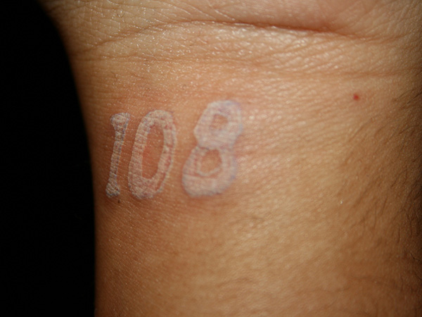 White Ink Number Tattoo On Wrist