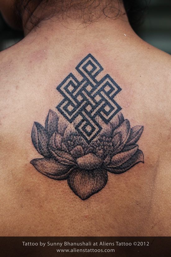 Wonderful Lotus Flower With Endless Knot Tattoo On Upper Back