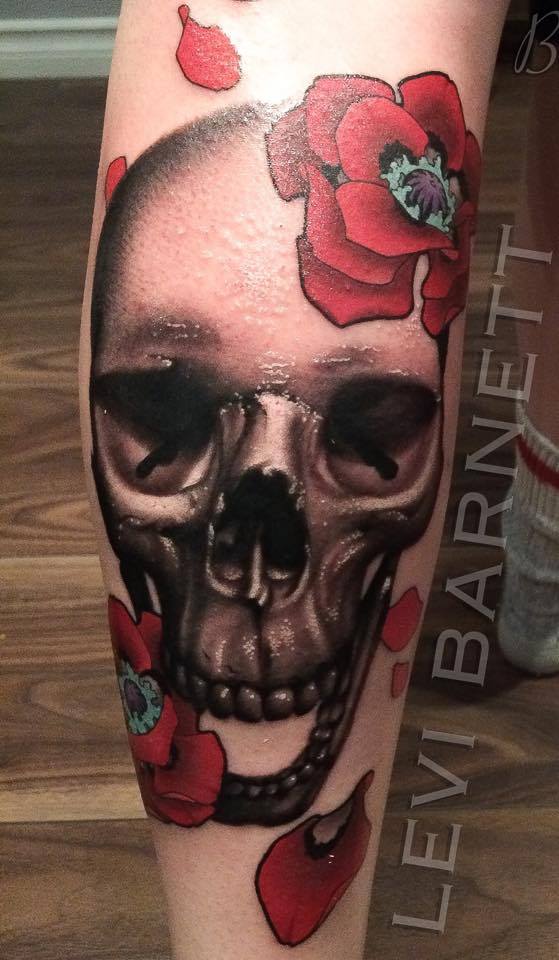 laughing skull with flowers tattoo on arm by Levi Barnett