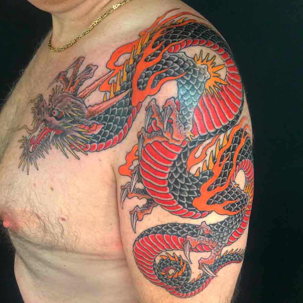 Amazing Color Ink Dragon Tattoo On Left Shoulder by Chris Garver