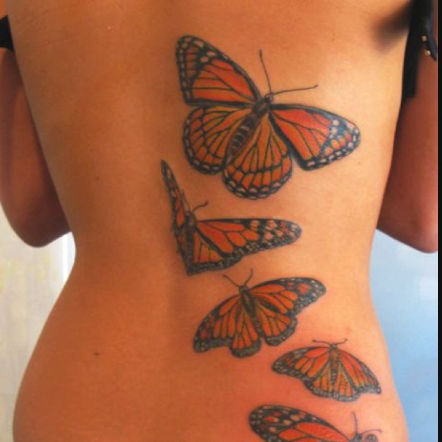 Awesome Monarch Butterflies Flying Tattoo On Girl Back Body