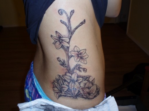 Beautiful Filipino Flowers Tattoo On Girl Side Rib
