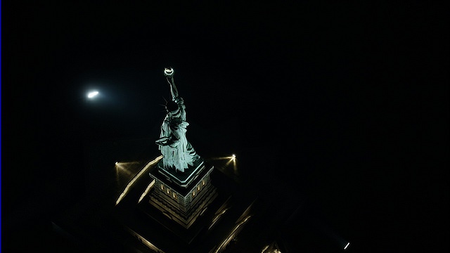 Bird's Eye Orbit Of The Statue Of Liberty At Night In New York